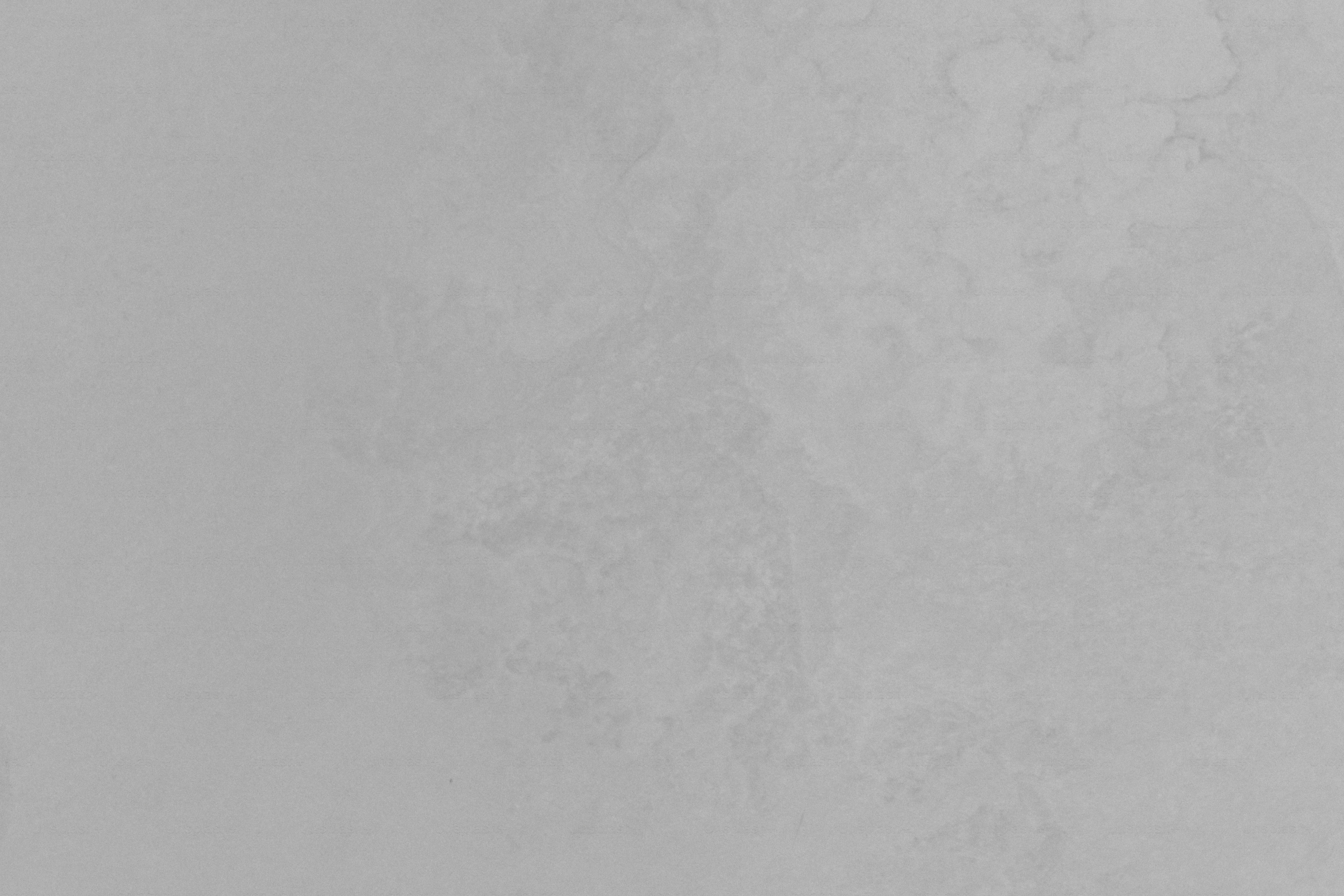 A gray, textured surface is shown.